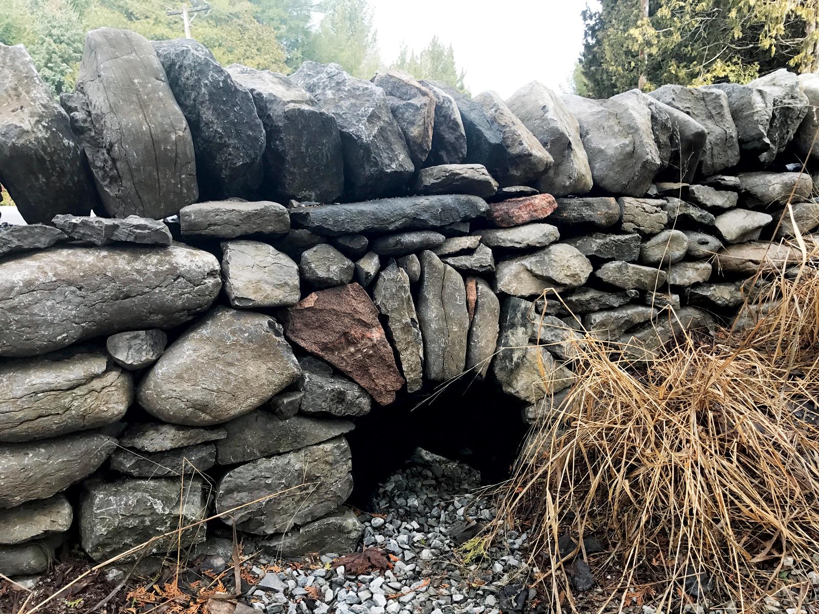 Dry stone culvert headwall with natural stone walling and drainage outlet in rural lancashire, stonework project by Ribble Landscapes